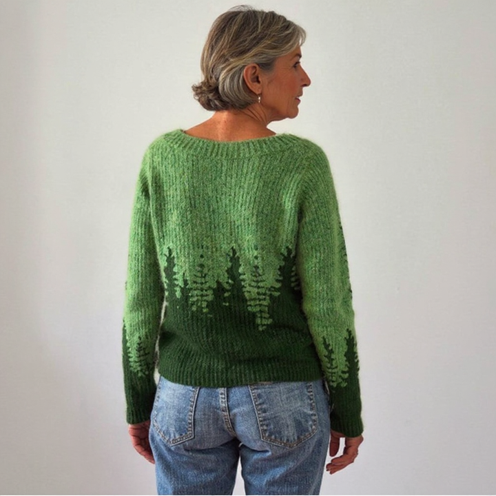 Maglione verde intrecciato con silhouette di foresta sull&