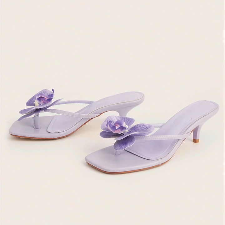 Sandali mule lilla con fiore e tacco basso
